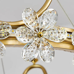 Close-up of a decorative light fixture with crystal-like flowers and gold accents.