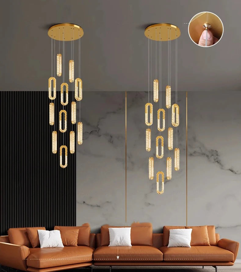 Modern chandelier hanging above a brown sofa with a marble wall and black curtain in the background.