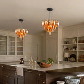 Amber faceted crystal chandelier with a tiered design hanging in a modern kitchen.