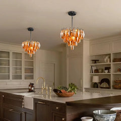 Amber faceted crystal chandelier with a tiered design hanging in a modern kitchen.