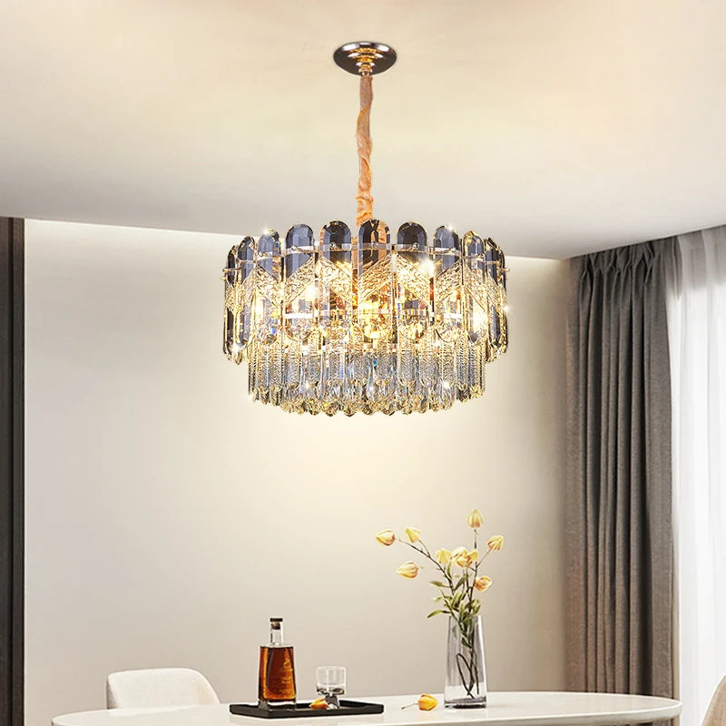 Close-up of the tiered gold crystal chandelier, showcasing the intricate crystal arrangement and polished gold frame.