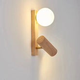 Close-up of a modern wood wall sconce with a frosted globe light and an adjustable wooden spotlight, mounted on a white wall.
