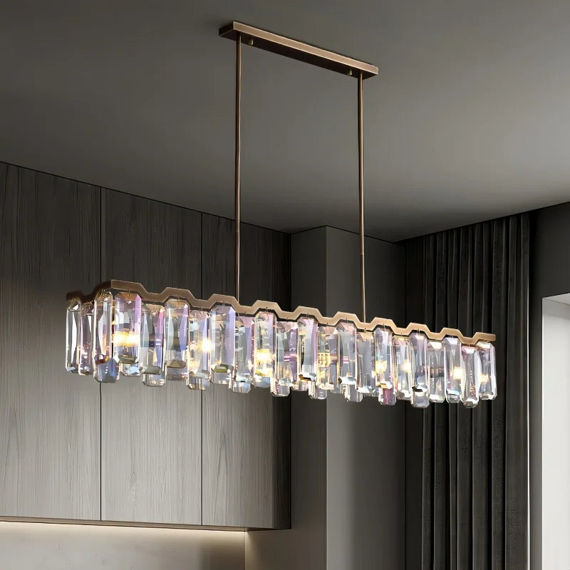 A polished chrome chandelier with faceted crystals installed in a room