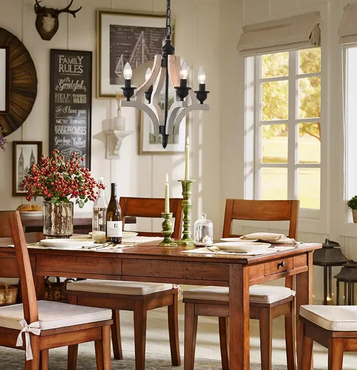 Dining room with wooden table and chairs, decorative elements, and large windows.