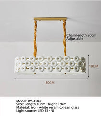 Chandelier with white ceramic design and gold chain on a gray background