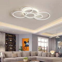 View of the gold interlocking ring flush mount light from a different angle in a bright room.