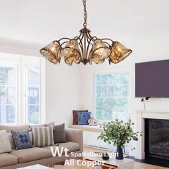 Living room with a copper floral chandelier with smoked glass shades over a sofa and coffee table.