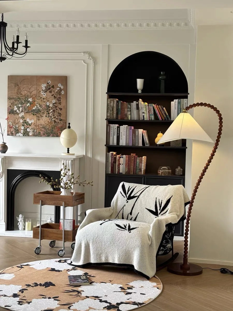 Living room with a bookshelf, armchair, and decorative items.