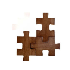 A group of three wooden puzzle pieces arranged to form a wall sconce, with a blurred white background suggesting illumination.