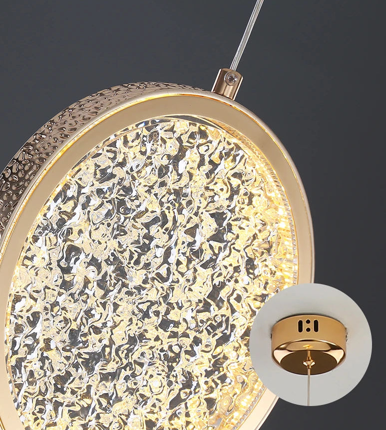 Close-up of a decorative ceiling light fixture with intricate design on a dark background