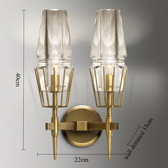 Wall-mounted lamp with gold fixture and clear glass shades, showing dimensions on a gray background.