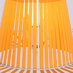 Close-up of a yellow and white striped fabric with a blurred background