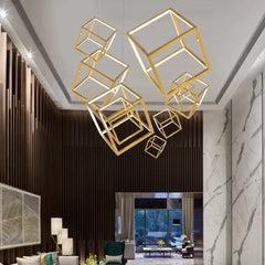 Modern interior with gold cube-shaped pendant lights in a stylish room.