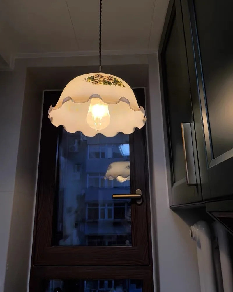 Light fixture with decorative shade hanging above a door