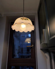 Light fixture with decorative shade hanging above a door