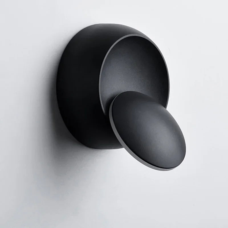 Black wall-mounted shower control on a light gray background