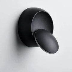Black wall-mounted shower control on a light gray background