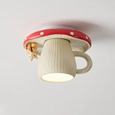 Close-up of a red and white mushroom-shaped ceiling light with a small squirrel hanging off the side, illuminating downwards.