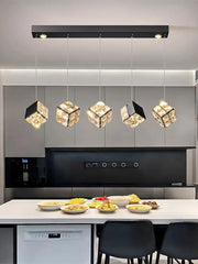 Modern kitchen with pendant lights and a dining table setup.