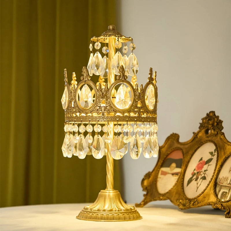 Decorative gold lamp with crystal accents on a surface with a blurred background