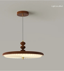 Wooden pendant light on a gray background with text indicating 'Light on effect'.