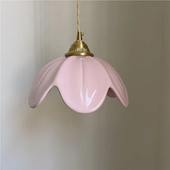 Close-up of the pink ceramic petal pendant light showing its texture and brass hardware.