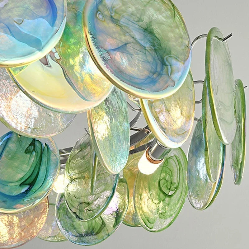 A detailed view of the glass discs within the chandelier, highlighting their swirling patterns and metallic sheen.
