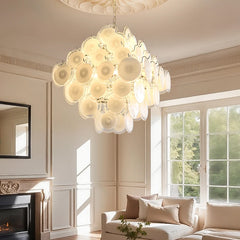 A bright living room scene featuring a large glass petal chandelier as the central light source.