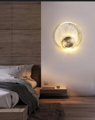 Modern bedroom with a wall-mounted light fixture casting a warm glow.