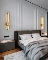 Modern bedroom with a bed, nightstands, and wall sconces.