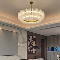 Close-up of the gold finish and layered acrylic shades of a wave chandelier