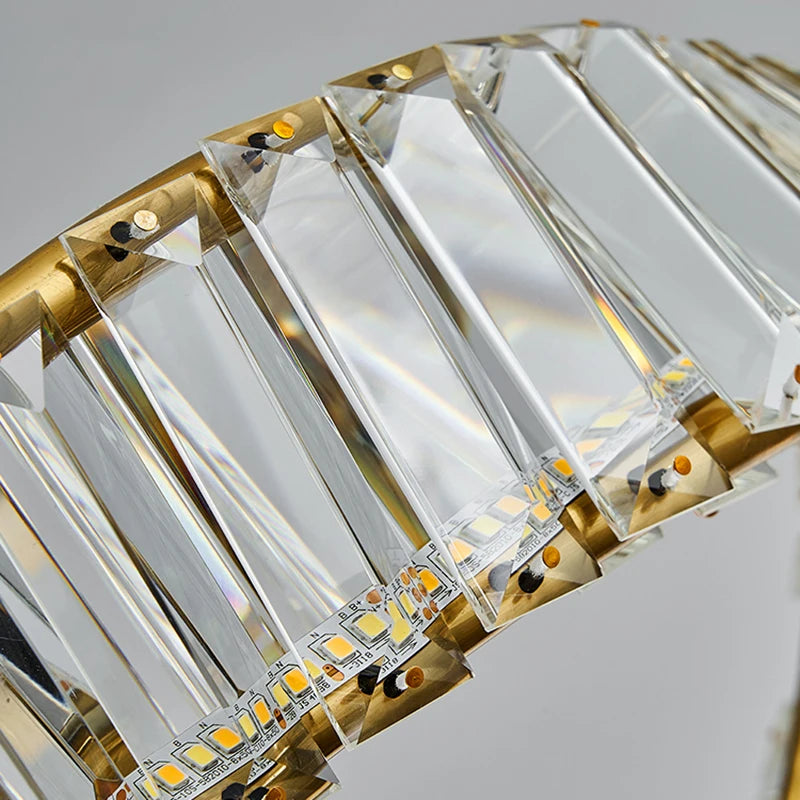 Close-up of a decorative light fixture with crystal-like panels and gold accents.