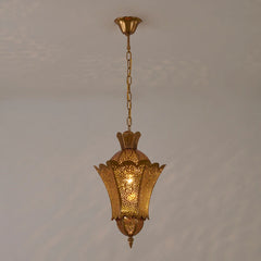 A gold hollow carved floral pendant light hanging from a chain against a plain background.