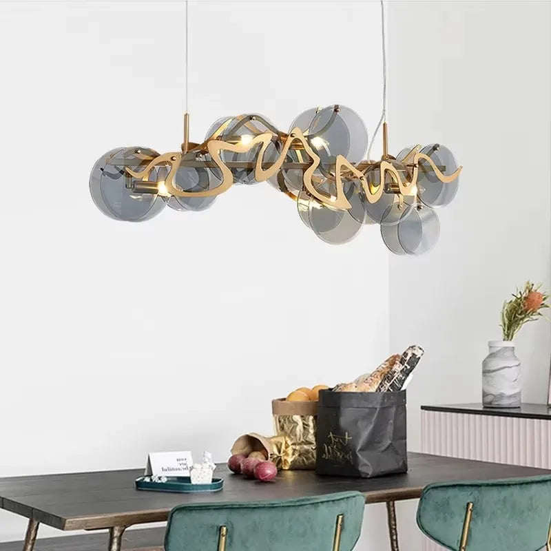 Gold wavy glass pendant light above a dining table