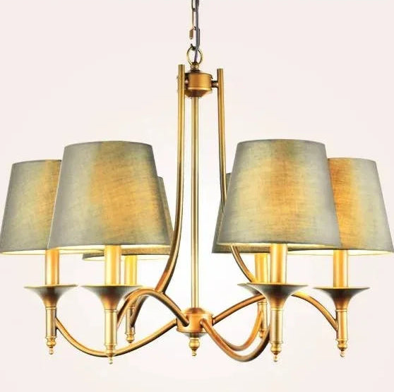 Chandelier with gold frame and gray lampshades on a light pink background