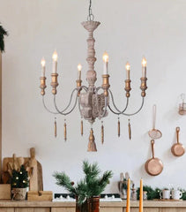Wooden chandelier hanging in a kitchen with decorative elements.