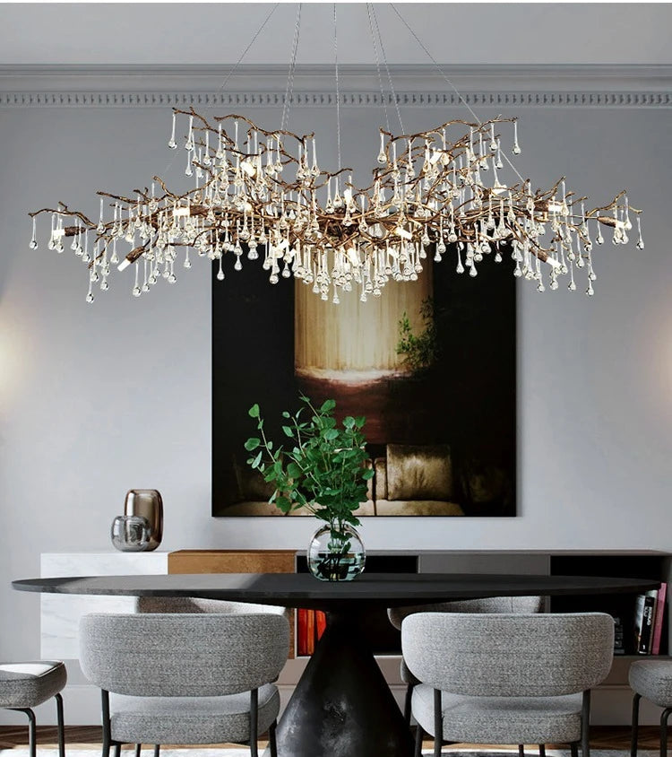 Dining room with a large chandelier, round table, and chairs.