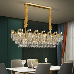 Close-up view of the gold cascading chandelier with teardrop crystals