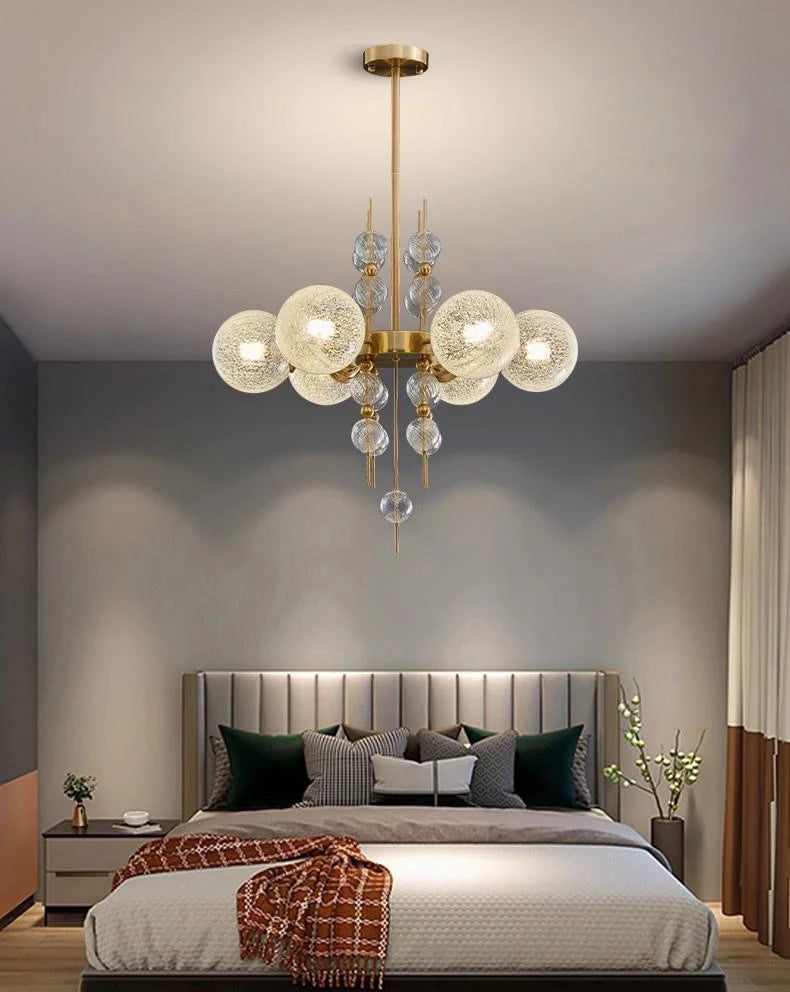 Modern bedroom with a chandelier, bed, and nightstands.