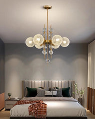 Modern bedroom with a chandelier, bed, and nightstands.