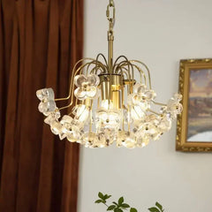 Angled view of a gold-tone floral glass pendant light with cascading elements.
