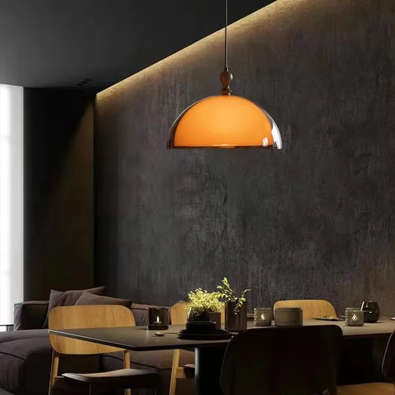 Amber glass dome pendant light in a modern living room setting