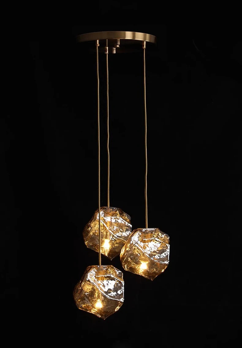 Modern pendant light with three glass shades on a black background