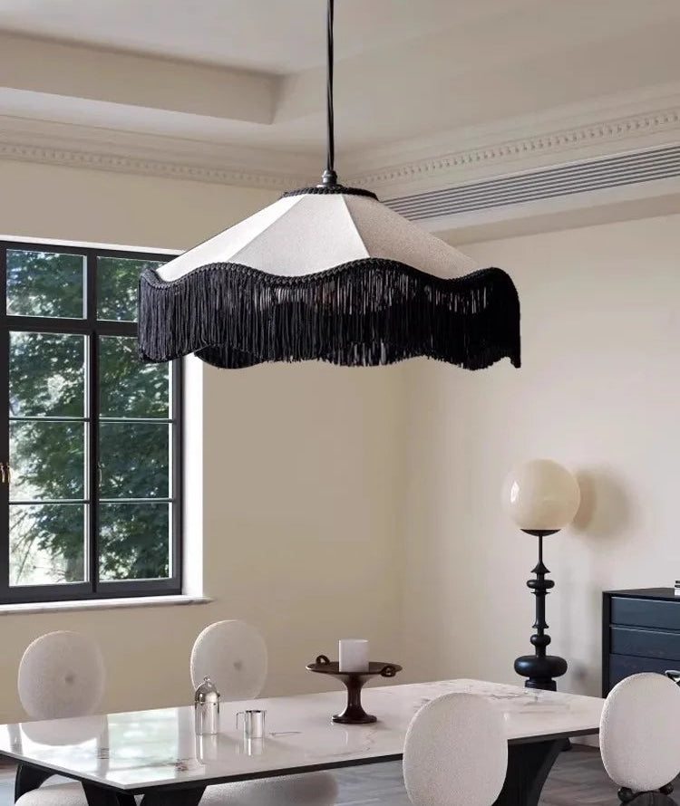 Modern dining room with a black and white pendant light fixture.