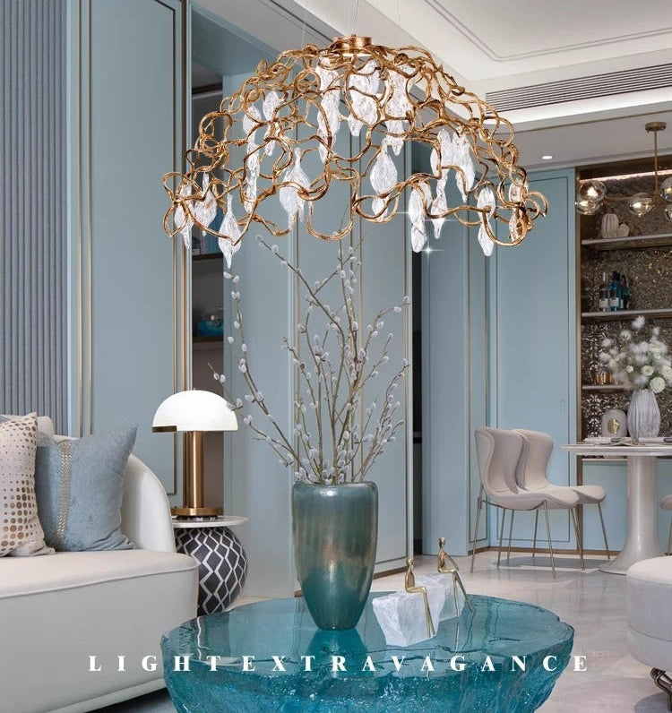 Luxurious chandelier in a modern living room setting with 'Light Extravagance' branding.
