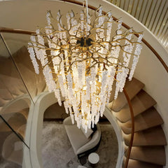 Luxurious chandelier hanging in a staircase with elegant decor