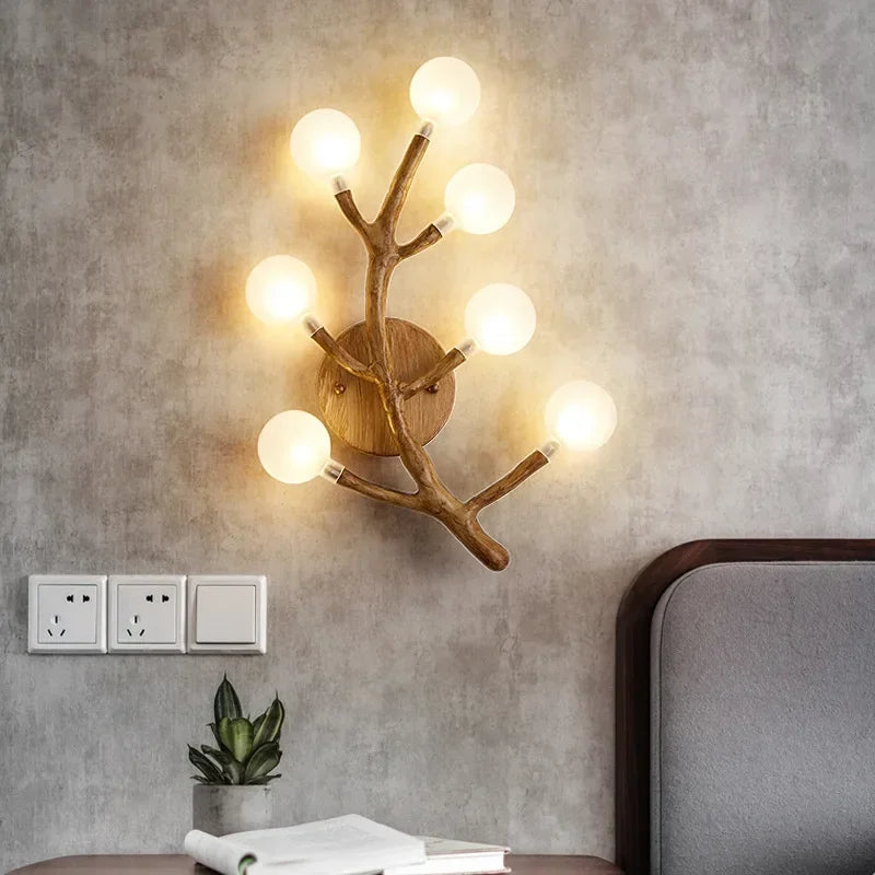 Wooden wall sconce with multiple lights on a textured wall.