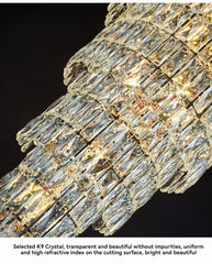 Close-up of a crystal chandelier with clear and gold crystals on a black background.