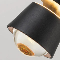 Close-up of a black and gold ceiling light fixture on a gray background