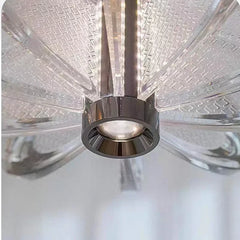 Close-up of a ceiling fan with clear blades and metallic hub.